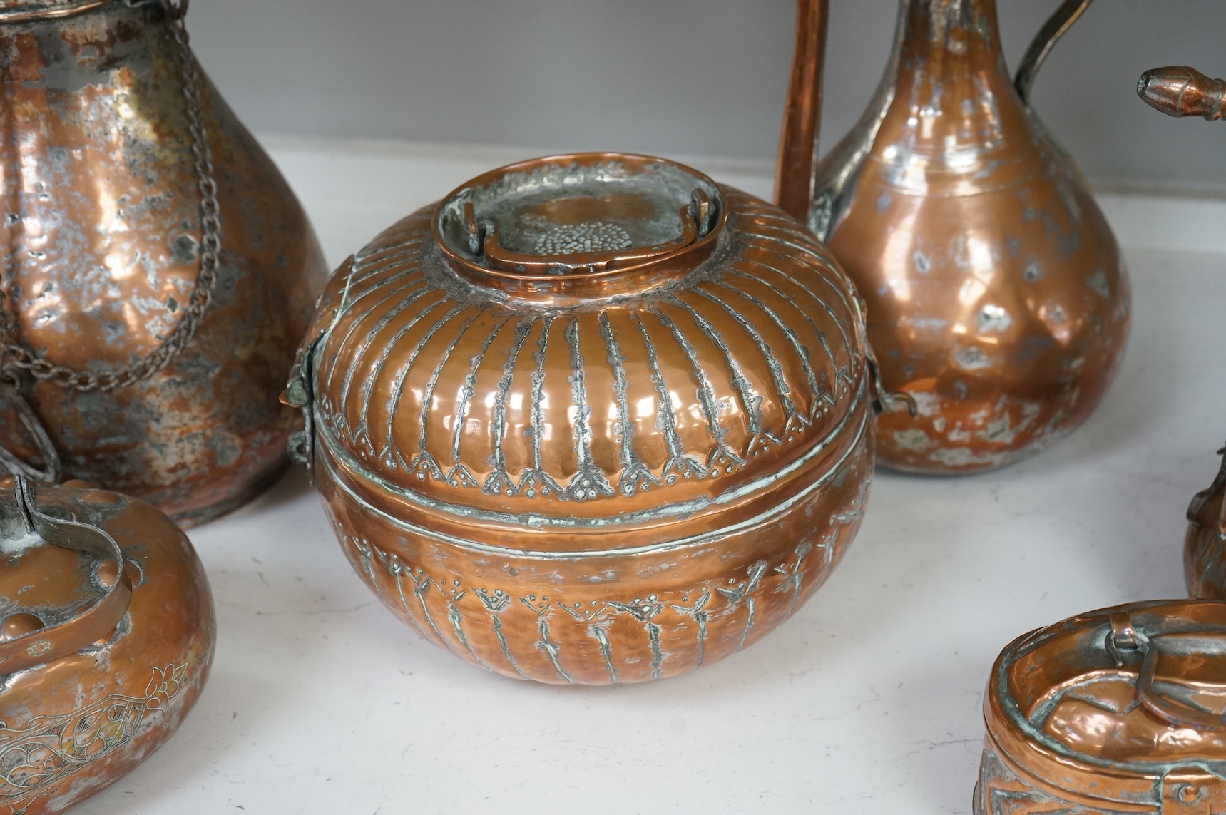 A collection of six various Arab copper vessels to include coffee pots, tallest 37cm